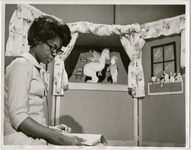 Woman reads on set of children's show