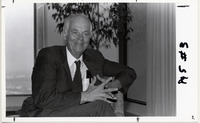 Roy H. Cullen sitting in a chair and smiling