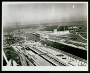 USS Houston (CA-30) in Houston Ship Channel, passing dockyards and approaching turning basin, taken from the air