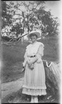 Woman standing next to a tree stump