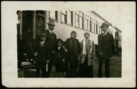 Family photo beside a train