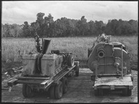 Two trucks carrying machinery at the site of an oil well in Brazoria County