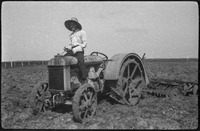Man sitting astride a tractor