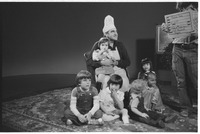 Chef Brockett holding child on lap while filming promotion for Mr. Rogers' Neighborhood