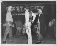Students dressed as outlaws near the Fiesta City gate