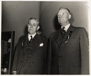 Hugh Roy Cullen standing next to a man