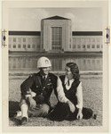 Two students by Reflection Pool in front of the Ezekiel Cullen Building