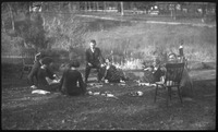 Group of people eating on grass
