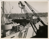 Crane loading vehicle onto ship