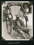 A man on a rickshaw