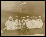 Elisabeth Holcombe (ship's sponsor) and a group of U.S. Navy officers on platform at USS Houston (CA-30) launching ceremony