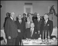 Group of men in front of a table