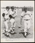 Luman Harris instructing Jerry Ard and Steve Hertz , in foot position in taking a lead off third base