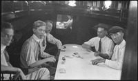Group of men playing poker in a boat