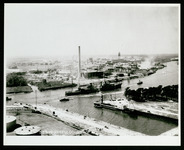 USS Houston (CA-30) in Houston Ship Channel, passing refinery, taken from the air
