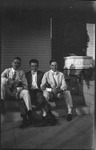 Three young men sitting on steps