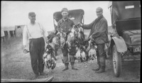 Group of hunters pose with ducks