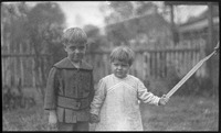 Children stand in a yard
