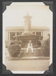 A Navy sailor sitting at a fountain