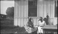 Two women sitting at an outside table