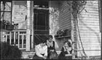 Three women on the front steps of a house