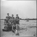 Group of people on beach with cat