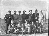 Men posing at oil well site