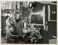 Two men working on a machine