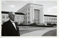 Hugh Roy Cullen standing in front of the Ezekiel Cullen Building