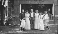 Group of people in front of a brick house