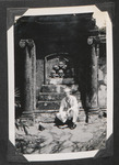 Navy sailor kneeling by a vault in Paco Cemetery