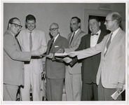 KUHT donors handing checks to John Schwarzwalder