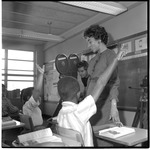Students raise their hands as Paul Schlessinger films 
