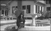 Woman sitting by a fountain