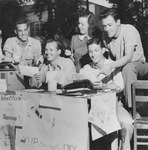 Group of students sitting at table with election posters