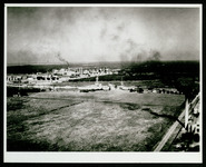 USS Houston (CA-30) in Houston Ship Channel with refinery in background, taken from the air