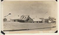 Cluster of houses submerged in sand