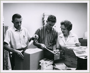 Charles Hardlick, Tom Requs, and Maxine Farris pack boxes