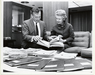 Jan De Hartog viewing a book with Marian Orgain