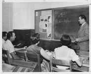 College of Business professor lecturing to a class