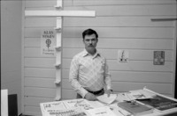 Man standing behind table at the Ku Klux Klan Information Center