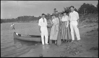 Group standing in front of a canoe