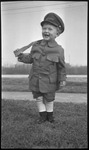 Boy in marine outfit holding toy gun