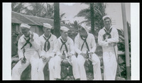 Five crew members seated with beer