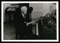 Arthur Rubinstein sits at piano
