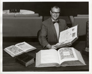 Edward G. Holley demonstrating rare books