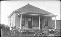 Dog standing on front porch of a house