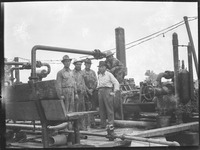 Group of men near machinery