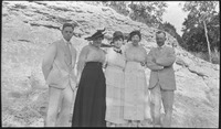 Group of people in front of a rocky formation