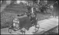 Boy in pedal car